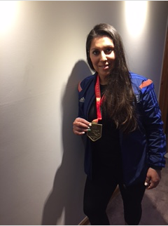 Muna Saleem in a tracksuit with a marathon medal around her neck