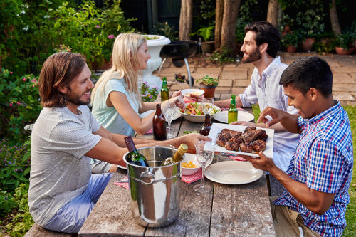 four people sat at an outside dinner table to discuss divorce